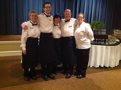Smiling  As You Like It staff members in tux shirts, black slacks & shoes, bow ties