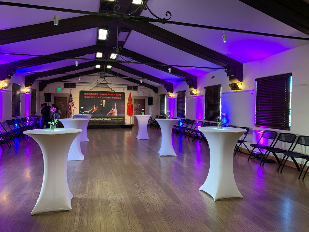 Picture of cocktail hour reception area, inside a banquet hall, with cocktail tables dressed with spandex linens